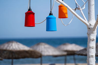 Clothes hanging on beach against clear blue sky