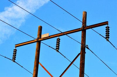 Low angle view of cables against clear blue sky