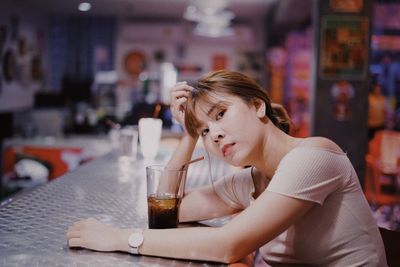 Young woman drinking glasses on table at restaurant