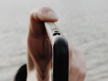 Cropped hand of woman holding thermometer