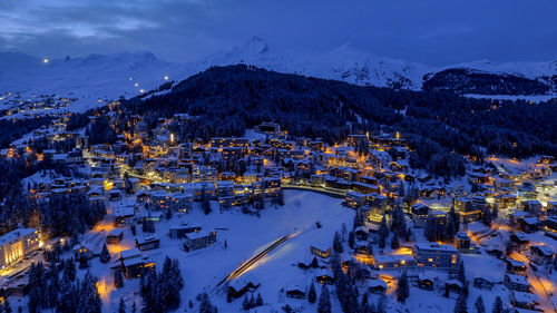 High angle view of illuminated buildings in city during winter