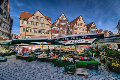 Graffiti on bridge against sky in city