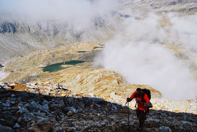 Hiker walking against volcanic crater