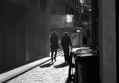 Rear view of people walking in city