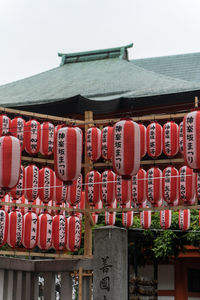 Illuminated lanterns hanging by building