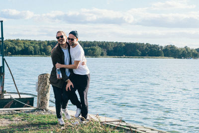 Full length of man wearing sunglasses against lake