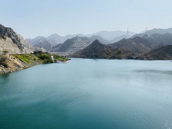 Scenic view of sea and mountains against sky