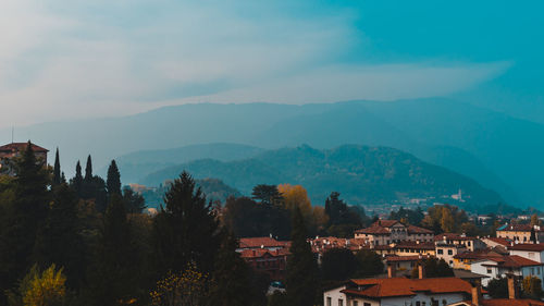 View of townscape and mountains against sky