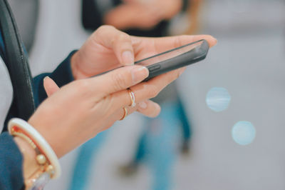 Midsection of woman using mobile phone