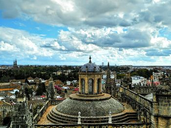 Cityscape against cloudy sky