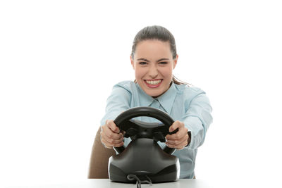 Portrait of smiling young woman against white background