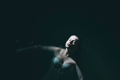 High angle view of woman relaxing in swimming pool