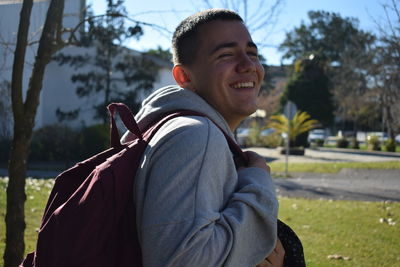 Portrait of smiling young man against plants