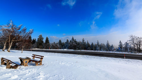 Scenic view of snow covered field against sky