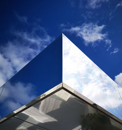 Low angle view of modern building against blue sky