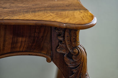 Close-up of wooden chair against the sky