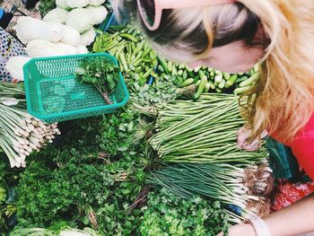 High angle view of woman holding vegetables in market