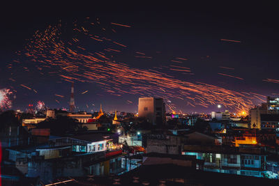 High angle view of illuminated buildings in city at night