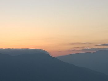 Scenic view of silhouette mountains against sky during sunset