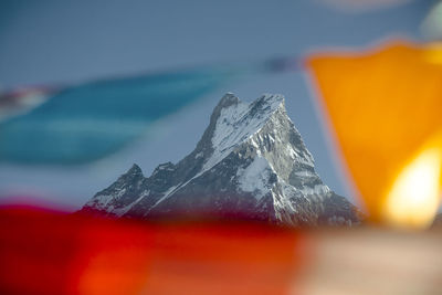 Close-up of snow on mountain against sky