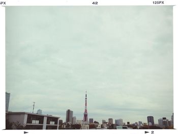 Skyscrapers against cloudy sky