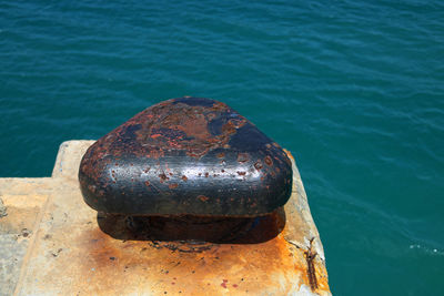 High angle view of rusty metal on sea