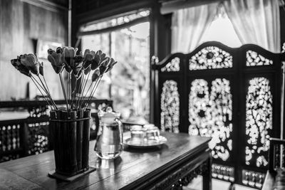 Close-up of flowers in vase on table at home