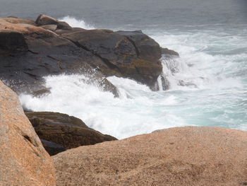 Waves splashing on rocks at shore
