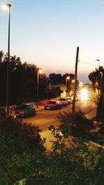 Cars on road at sunset