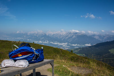 Scenic view of land and mountains against blue sky