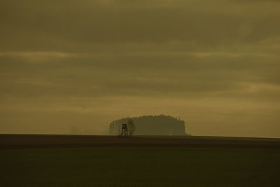 Scenic view of field against sky during sunset