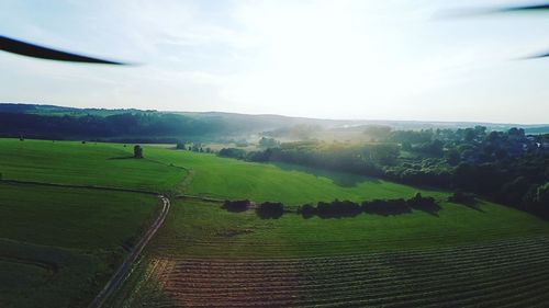 Scenic view of field against cloudy sky