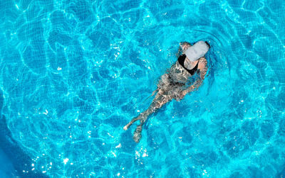 High angle view of man swimming in pool