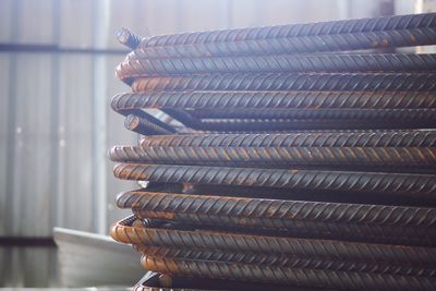 Close-up of stacked metallic rods in factory