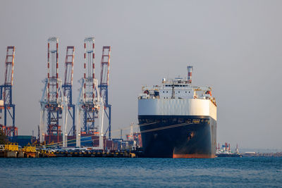 Boats in sea against clear sky