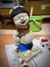 Close-up of buddha statue on table