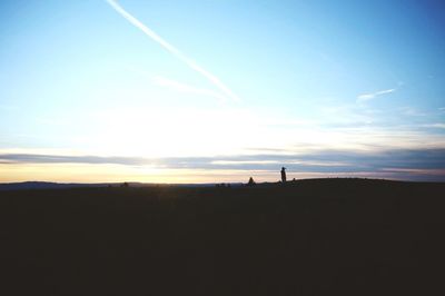 Silhouette of landscape against sky at sunset