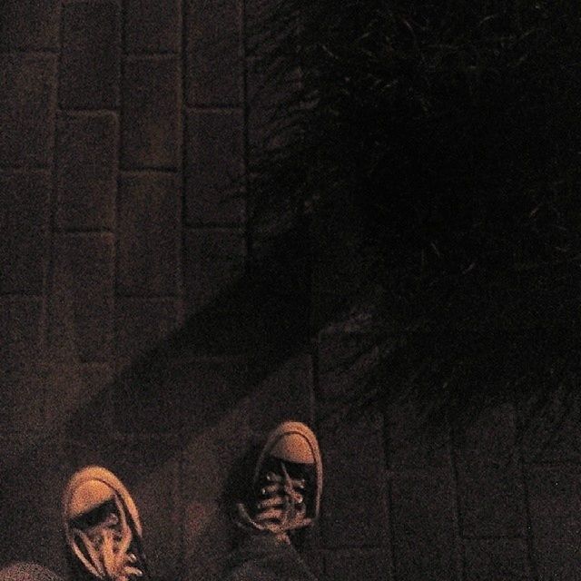 low section, shoe, person, lifestyles, standing, personal perspective, high angle view, unrecognizable person, leisure activity, footwear, men, shadow, wall - building feature, street, human foot, indoors, night