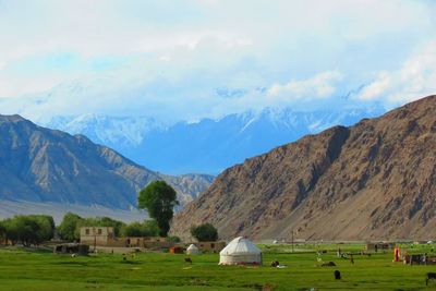 Scenic view of mountains against cloudy sky