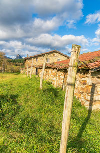 View of wooden fence on field against sky