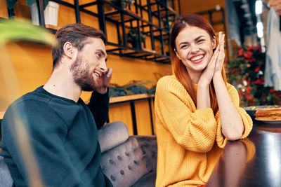 Smiling woman with man at cafe