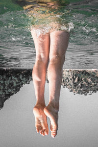 Low section of man standing on beach