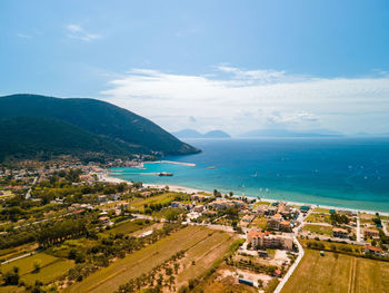 High angle view of townscape by sea against sky