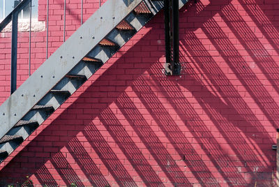 Low section of person on pink building