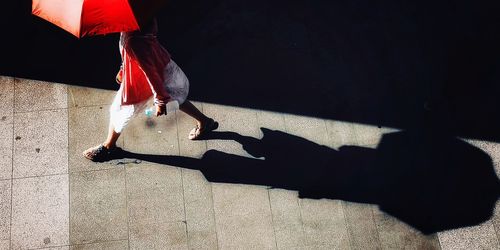 Low section of people walking on street