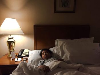 High angle view of boy sleeping on bed at home