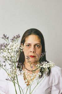 Hispanic woman holding baby's breath flower