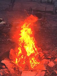 Bonfire on wooden structure in field