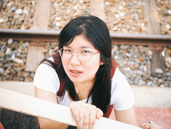 Portrait of a young woman sitting outdoors