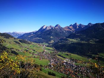 Scenic view of mountains against clear blue sky